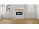Bright and airy living room featuring a decorative fireplace, mantle, and new wood flooring at 1610 Savoy Way Way, Loganville, GA 30052