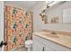 Bright bathroom featuring a single sink vanity, decorative mirror, and a colorful shower curtain at 1750 Clairmont Rd # 32, Decatur, GA 30033