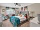 Stylish bedroom with plush teal bedding, colorful accents, and ample natural light from a large window at 1750 Clairmont Rd # 32, Decatur, GA 30033