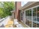 Outdoor wooden deck overlooking wooded backyard, featuring a brick chimney and sliding glass doors at 1750 Clairmont Rd # 32, Decatur, GA 30033