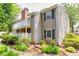Exterior view of home featuring neutral siding, classic shutters, and a charming, landscaped yard at 1750 Clairmont Rd # 32, Decatur, GA 30033