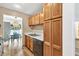 Galley kitchen featuring wood cabinets, white countertops and view into a naturally lit breakfast area at 1750 Clairmont Rd # 32, Decatur, GA 30033