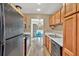 Galley kitchen featuring wood cabinets, white countertops and adjacent breakfast area filled with natural light at 1750 Clairmont Rd # 32, Decatur, GA 30033