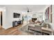 Sun-filled living room with backyard views, comfortable sofa, fireplace, and stylish wood flooring at 1750 Clairmont Rd # 32, Decatur, GA 30033