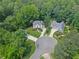 Aerial view of homes in a lush, green neighborhood showcasing meticulously landscaped yards at 305 Jasmine Ct, Woodstock, GA 30189