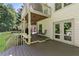 Comfortable outdoor living space featuring a spacious deck with seating and access to the backyard at 305 Jasmine Ct, Woodstock, GA 30189