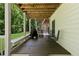 Relaxing outdoor space featuring a spacious deck with seating and views of the lush backyard at 305 Jasmine Ct, Woodstock, GA 30189