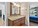 Bathroom with granite countertop vanity, wood cabinets, mirror, and lighting at 305 Jasmine Ct, Woodstock, GA 30189