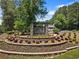 Welcoming community entrance sign with lush landscaping in a tranquil setting at 305 Jasmine Ct, Woodstock, GA 30189