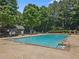Sparkling community pool with lounge chairs, umbrellas, and seating for residents at 305 Jasmine Ct, Woodstock, GA 30189
