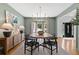 Stylish dining area featuring a wooden table, modern lighting and neutral walls at 305 Jasmine Ct, Woodstock, GA 30189