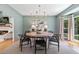 Well-lit dining room with modern chandelier and neutral color palette at 305 Jasmine Ct, Woodstock, GA 30189
