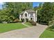 Charming two-story home featuring a well-manicured lawn and a welcoming driveway at 305 Jasmine Ct, Woodstock, GA 30189