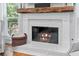 Close up of fireplace with marble details and wooden mantle at 305 Jasmine Ct, Woodstock, GA 30189