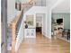 Inviting foyer with hardwood floors, staircase, and view to the living room at 305 Jasmine Ct, Woodstock, GA 30189