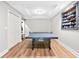 Spacious rec room area with ping pong table and custom hat display at 305 Jasmine Ct, Woodstock, GA 30189