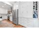 This kitchen features custom cabinets, stainless appliances and wine storage at 305 Jasmine Ct, Woodstock, GA 30189