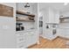 Bright kitchen features custom cabinets, open shelving and a beverage center at 305 Jasmine Ct, Woodstock, GA 30189