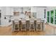 Kitchen island with barstool seating, sleek countertops and modern stainless appliances at 305 Jasmine Ct, Woodstock, GA 30189
