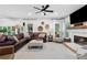 Spacious living room with fireplace, large windows, and comfortable furnishings at 305 Jasmine Ct, Woodstock, GA 30189