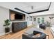 Finished basement living room with a mounted TV, custom cabinetry, and stylish seating at 305 Jasmine Ct, Woodstock, GA 30189