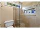 Tiled shower with glass door and shampoo niche at 305 Jasmine Ct, Woodstock, GA 30189