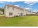 A spacious backyard with lush lawn, patio seating, and charming landscaping creates an inviting outdoor oasis at 6637 Chason Woods Ct, Jonesboro, GA 30238