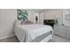 Cozy bedroom with cool-toned walls, soft carpet, and modern art, perfect for restful nights and peaceful mornings at 6637 Chason Woods Ct, Jonesboro, GA 30238
