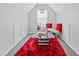 Unique bonus room or reading nook with bright red rug and throw pillows for relaxing at 6637 Chason Woods Ct, Jonesboro, GA 30238