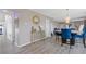 Open concept dining area featuring modern light fixture and stylish decor with blue chairs at 6637 Chason Woods Ct, Jonesboro, GA 30238