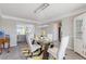 Elegant dining room featuring modern chandelier and stylish glass table with seating for four at 6637 Chason Woods Ct, Jonesboro, GA 30238