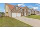 Charming two-story brick and stone home with an attached two-car garage and well-maintained yard at 6637 Chason Woods Ct, Jonesboro, GA 30238