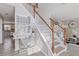 Bright foyer featuring a staircase with wooden handrail, a mirrored accent table, and stylish decor at 6637 Chason Woods Ct, Jonesboro, GA 30238