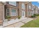 Welcoming front entrance with stone accents, a white front door, and meticulously landscaped surroundings at 6637 Chason Woods Ct, Jonesboro, GA 30238