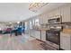Spacious kitchen with gray cabinets, stainless steel appliances, and adjacent dining area at 6637 Chason Woods Ct, Jonesboro, GA 30238