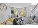 Bright living room with bay windows, mirrored furniture, and elegant staircase at 6637 Chason Woods Ct, Jonesboro, GA 30238
