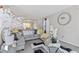 Cozy living room featuring stylish gray sectional sofa, mirrored tables, and accent decor at 6637 Chason Woods Ct, Jonesboro, GA 30238