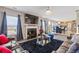 Comfortable living room area featuring a fireplace, modern chandelier and view of dining and kitchen area at 6637 Chason Woods Ct, Jonesboro, GA 30238