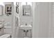 Neat bathroom featuring vintage fixtures, a pedestal sink, and tiled shower, highlighting a blend of classic style at 130 26Th St # 402, Atlanta, GA 30309