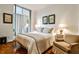 Bedroom features neutral decor, hardwood floors and a sliding glass door at 130 26Th St # 402, Atlanta, GA 30309
