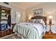 Comfortable bedroom with a well-dressed bed, wooden floors, and open closet for easy access and storage at 130 26Th St # 402, Atlanta, GA 30309