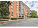 Brick building exterior featuring a covered entrance and manicured hedges and landscaping at 130 26Th St # 402, Atlanta, GA 30309