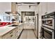 Modern kitchen with white cabinetry, stainless steel appliances and eat-in island at 130 26Th St # 402, Atlanta, GA 30309