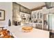 Bright kitchen with stainless steel appliances, white cabinetry, and exposed brick and concrete walls at 130 26Th St # 402, Atlanta, GA 30309