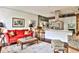 Open-concept living area features a kitchen, red sofa, and hardwood floors at 130 26Th St # 402, Atlanta, GA 30309