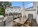 Inviting back deck with a wooden table set, grill, and a view of neighboring townhomes at 2505 Astaire Nw Ct, Atlanta, GA 30318