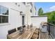 Back deck with a wooden table, outdoor lighting, and a grill, perfect for entertaining and relaxation at 2505 Astaire Nw Ct, Atlanta, GA 30318