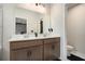 Modern bathroom with double sinks, sleek cabinetry, and a large vanity mirror at 2505 Astaire Nw Ct, Atlanta, GA 30318