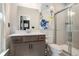 Modern bathroom features a vanity with gray cabinets, white countertop and a glass-enclosed shower at 2505 Astaire Nw Ct, Atlanta, GA 30318