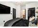 Bedroom featuring black and gold bedding, TV, and ensuite bathroom at 2505 Astaire Nw Ct, Atlanta, GA 30318